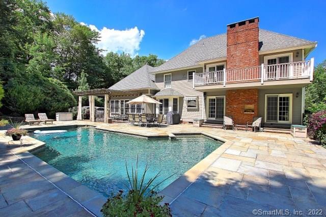 a view of a house with swimming pool and sitting area