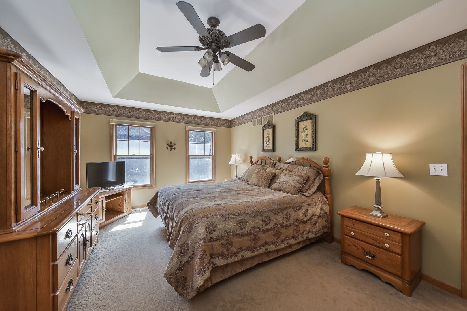 439 Lewis Road Geneva, IL 60134 - Photo 11 of 24 a bedroom with a bed a chandelier and dresser