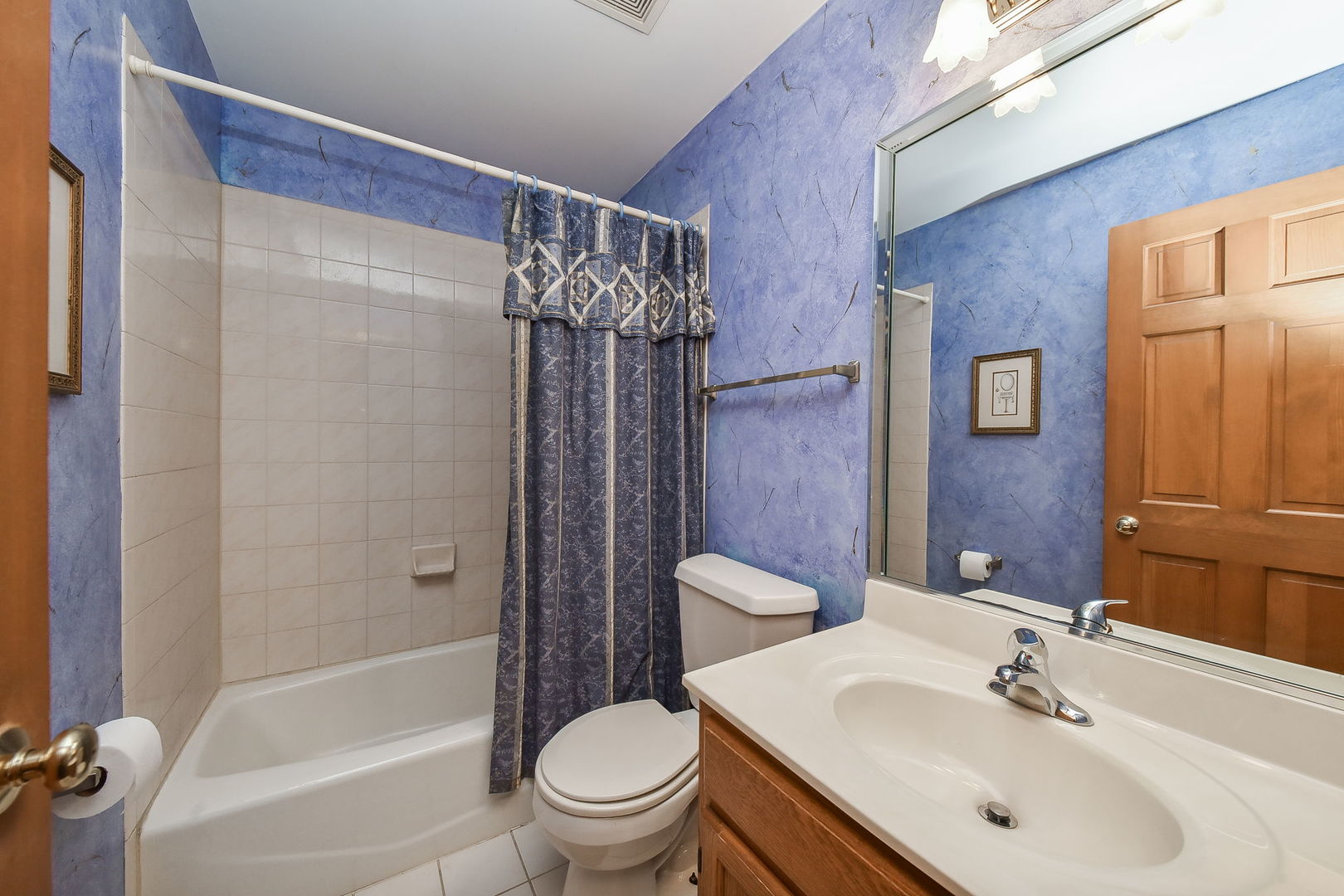 439 Lewis Road Geneva, IL 60134 - Photo 16 of 24 a bathroom with a sink toilet and shower