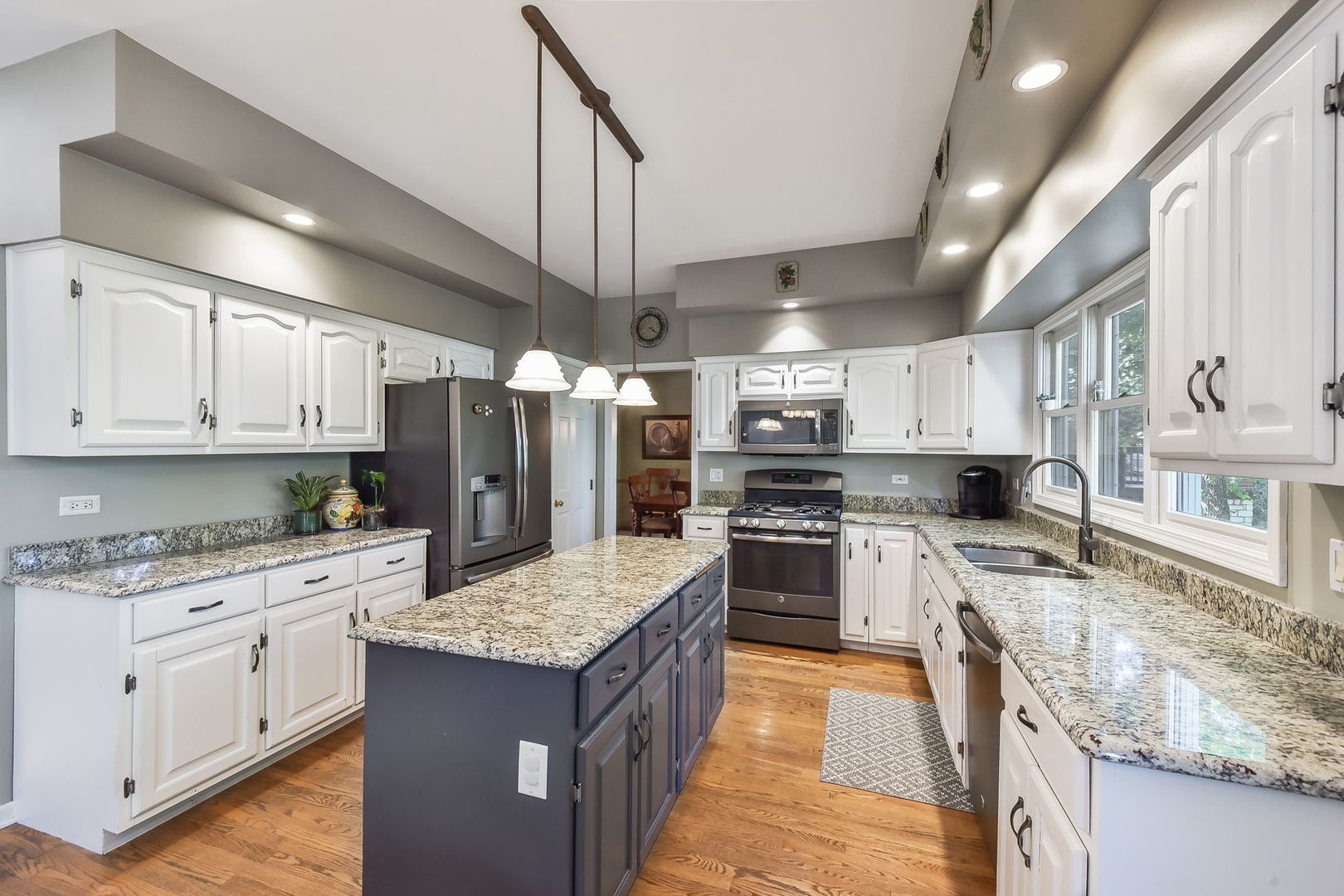 439 Lewis Road Geneva, IL 60134 - Photo 8 of 24 a kitchen with stainless steel appliances granite countertop a sink stove and refrigerator