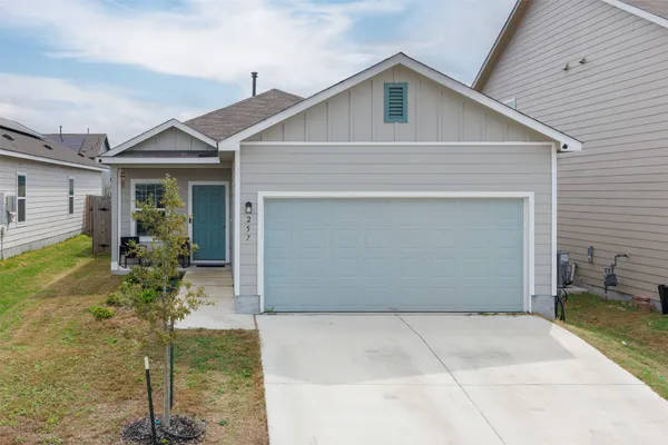 a front view of house with a garden