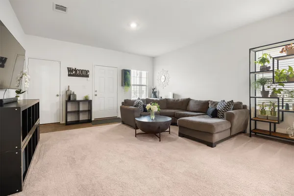 a view of a livingroom with furniture and a flat screen tv