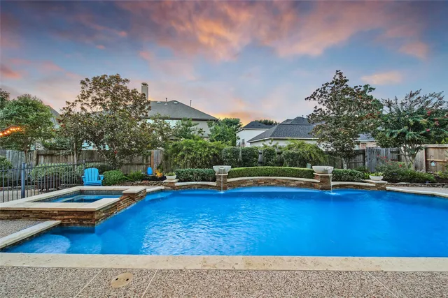 a view of swimming pool with outdoor seating and yard in back