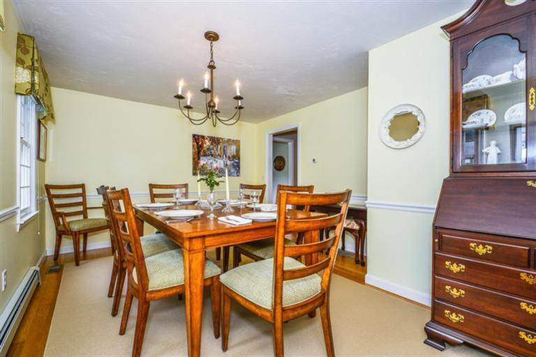 45 Long Hill Road Dennis, MA 02638 - Photo 12 of 26 a view of a dining room with furniture and chandelier