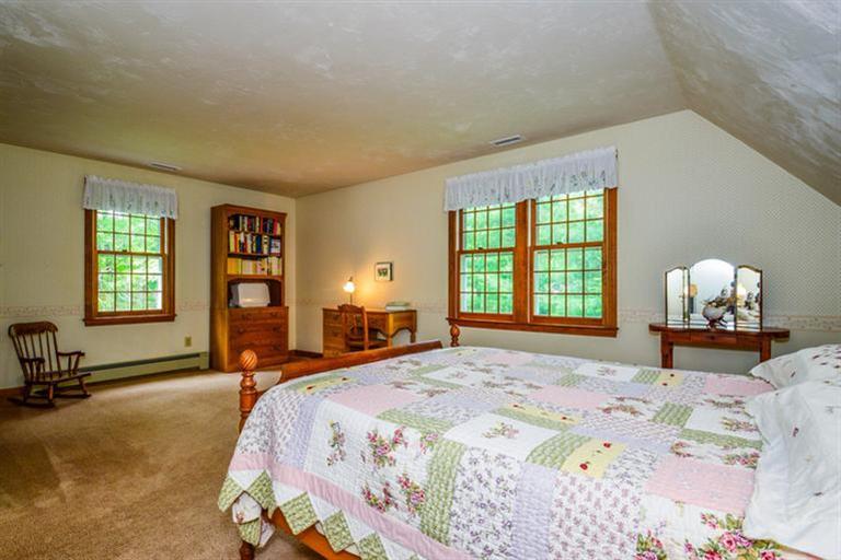 45 Long Hill Road Dennis, MA 02638 - Photo 16 of 26 a bedroom with a bed and large windows