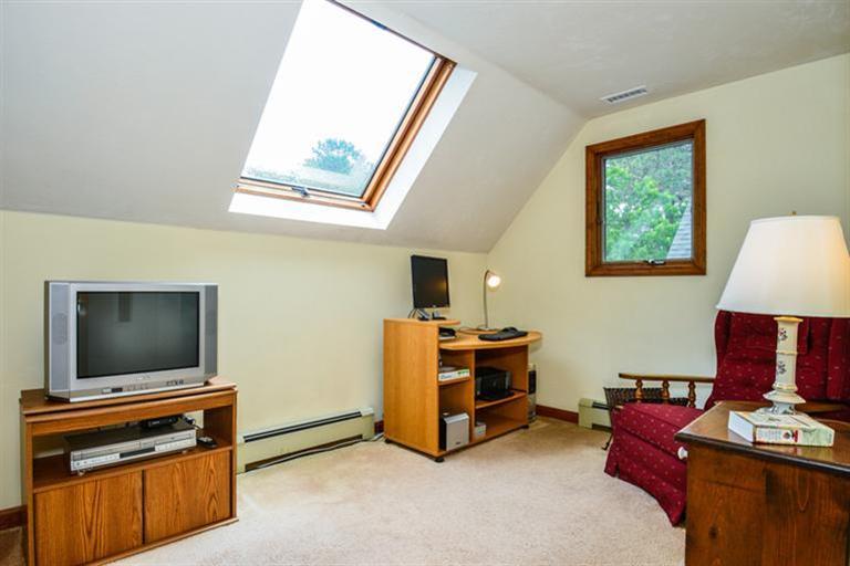 45 Long Hill Road Dennis, MA 02638 - Photo 19 of 26 a living room with furniture and a flat screen tv