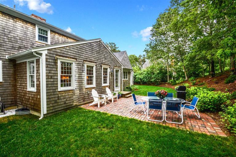 45 Long Hill Road Dennis, MA 02638 - Photo 22 of 26 a view of a chair and table in backyard of the house