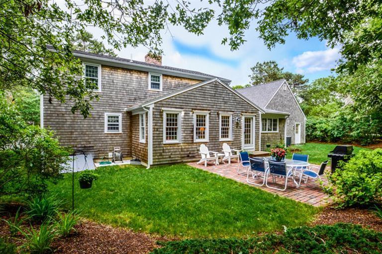 45 Long Hill Road Dennis, MA 02638 - Photo 23 of 26 a front view of house with yard and outdoor seating