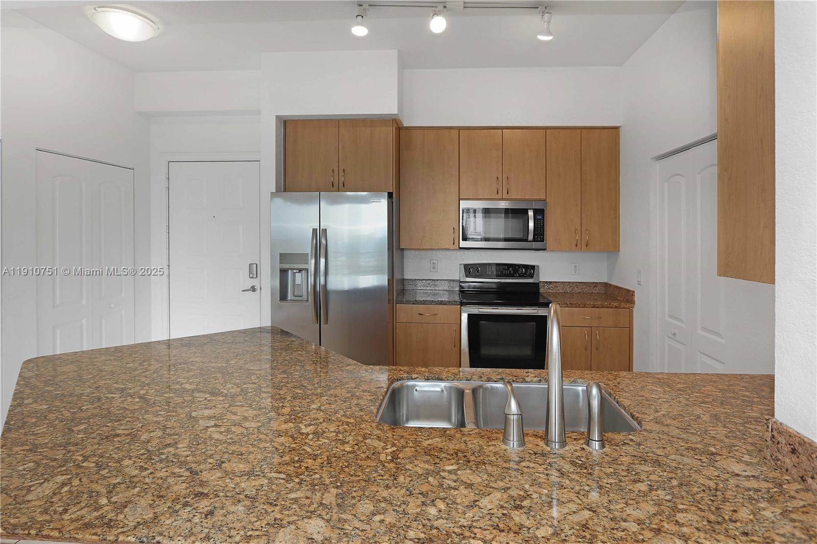 1830 Radius Drive, Unit 1119 Hollywood, FL 33020 - Photo 2 of 53 a kitchen with granite countertop a refrigerator and a stove top oven