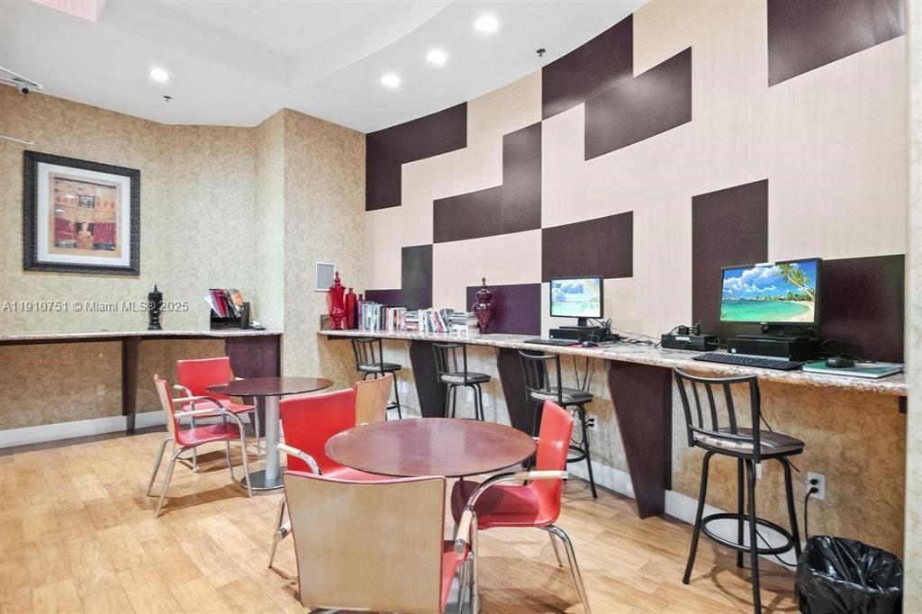 1830 Radius Drive, Unit 1119 Hollywood, FL 33020 - Photo 43 of 53 a outdoor dining space with furniture and flat screen tv