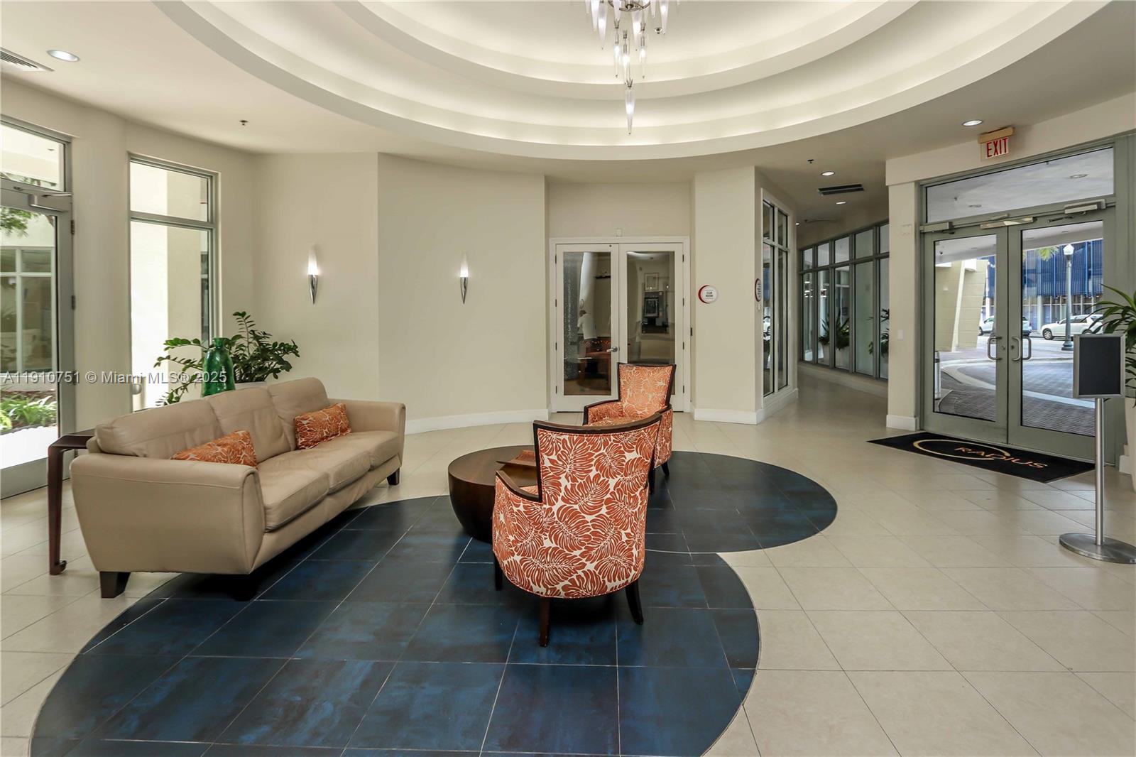 1830 Radius Drive, Unit 1119 Hollywood, FL 33020 - Photo 48 of 53 a living room with furniture and a chandelier