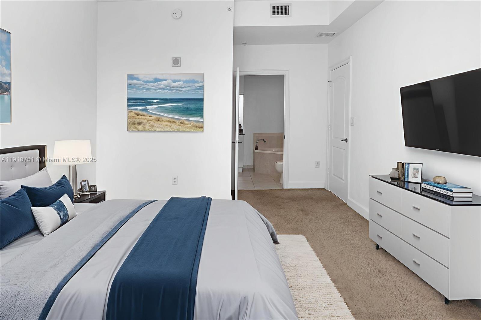 1830 Radius Drive, Unit 1119 Hollywood, FL 33020 - Photo 5 of 53 a bedroom with a bed and a flat screen tv