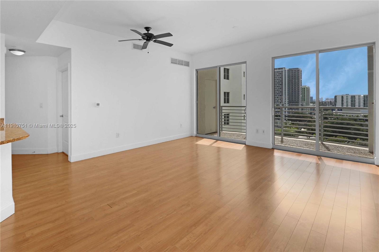 1830 Radius Drive, Unit 1119 Hollywood, FL 33020 - Photo 9 of 53 wooden floor in an empty room with a window