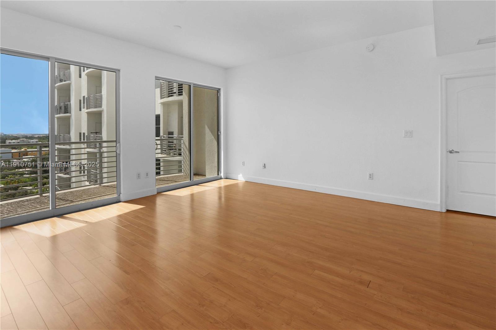 1830 Radius Drive, Unit 1119 Hollywood, FL 33020 - Photo 10 of 53 an empty room with wooden floor and windows