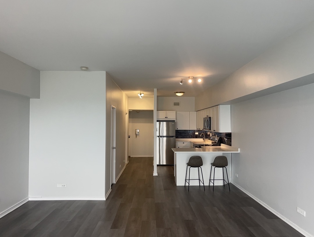 175 East Delaware Place, Unit 5004 Chicago, IL 60611 - Photo 6 of 17 a view of a kitchen with dining table and chairs