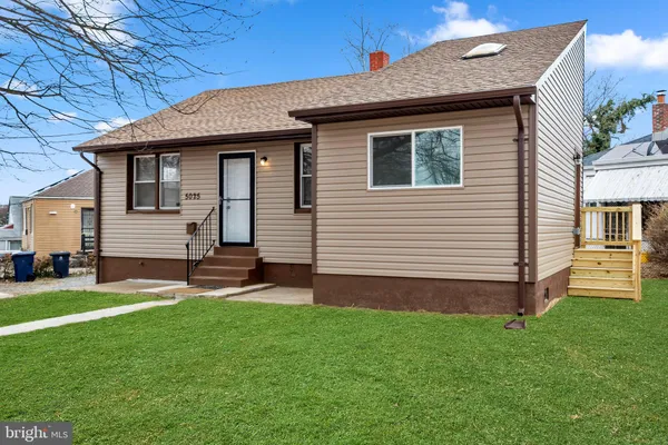 a front view of a house with a yard and table