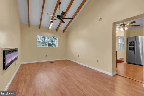 a view of empty room with wooden floor