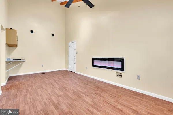 a view of a room with wooden floor