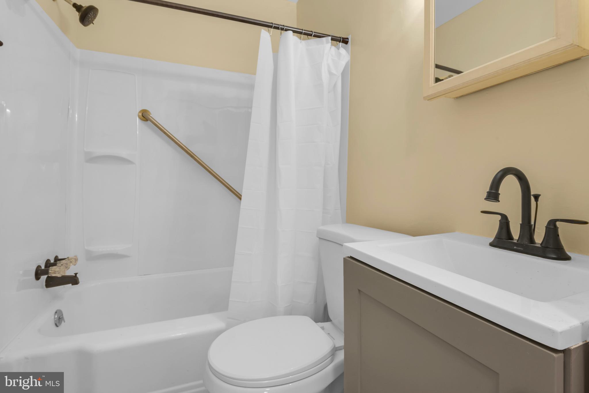 5025 Addison Road Capitol Heights, MD 20743 - Photo 17 of 37 a bathroom with a sink toilet and a bathtub