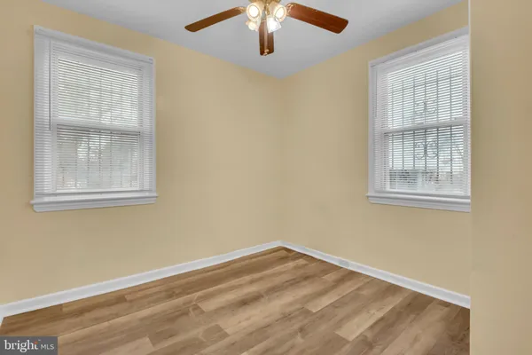 a view of a hallway with wooden floor and closet