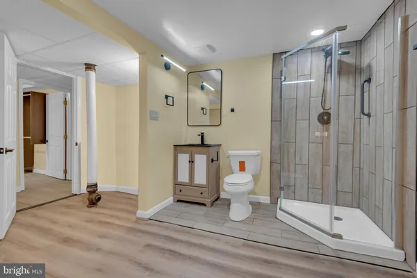 a bathroom with a shower a toilet and a sink