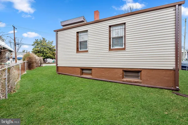a house view with a sitting space and garden