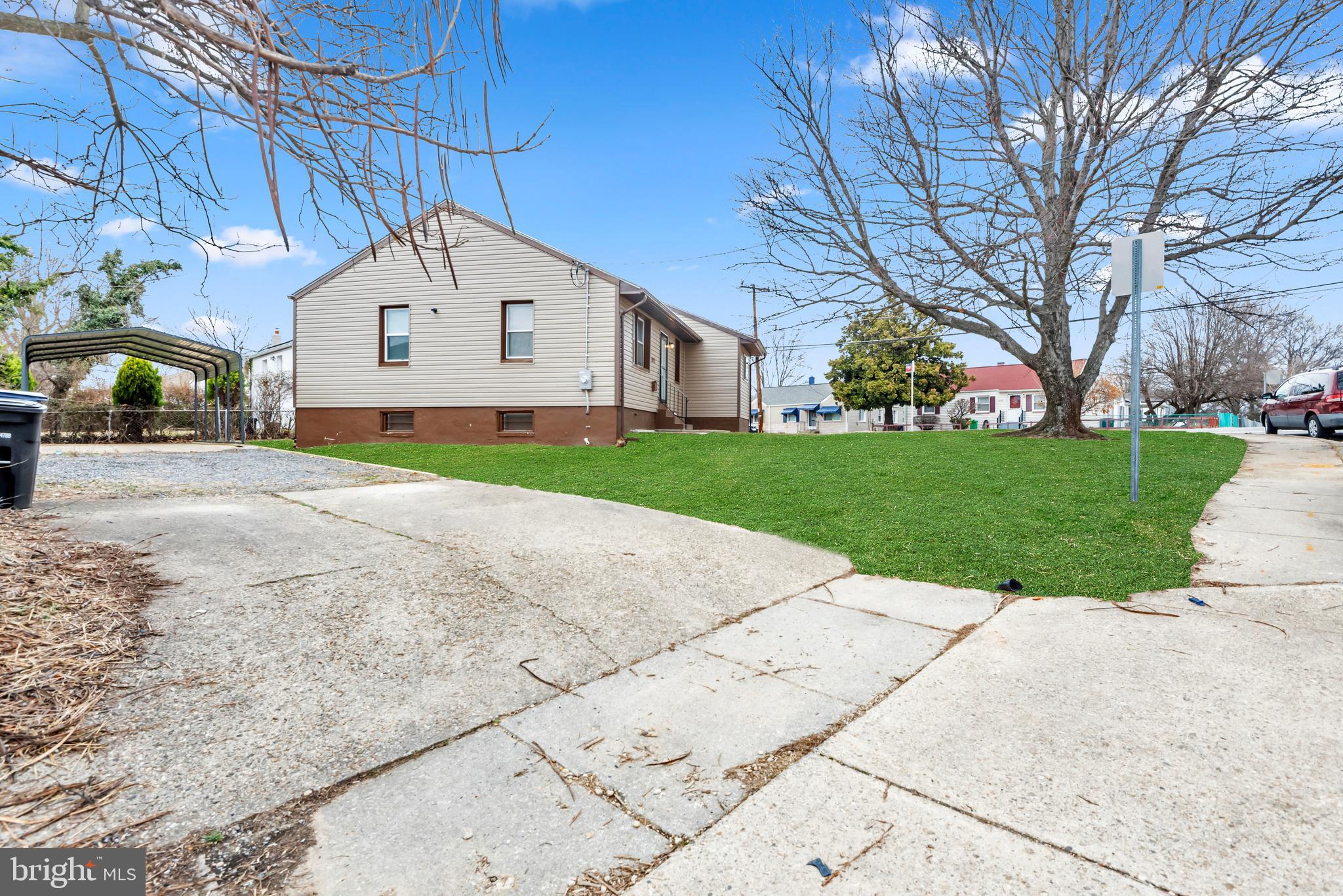 5025 Addison Road Capitol Heights, MD 20743 - Photo 36 of 37 a front view of a house with a yard and garage
