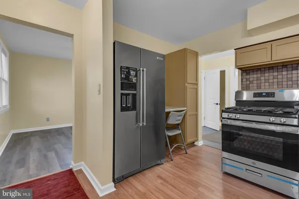 a view of kitchen with stove and refrigerator
