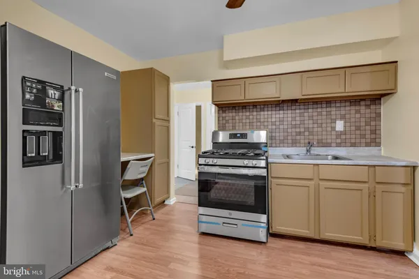 a kitchen with stainless steel appliances a stove and a refrigerator