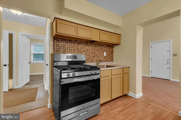 a kitchen with a stove and a sink