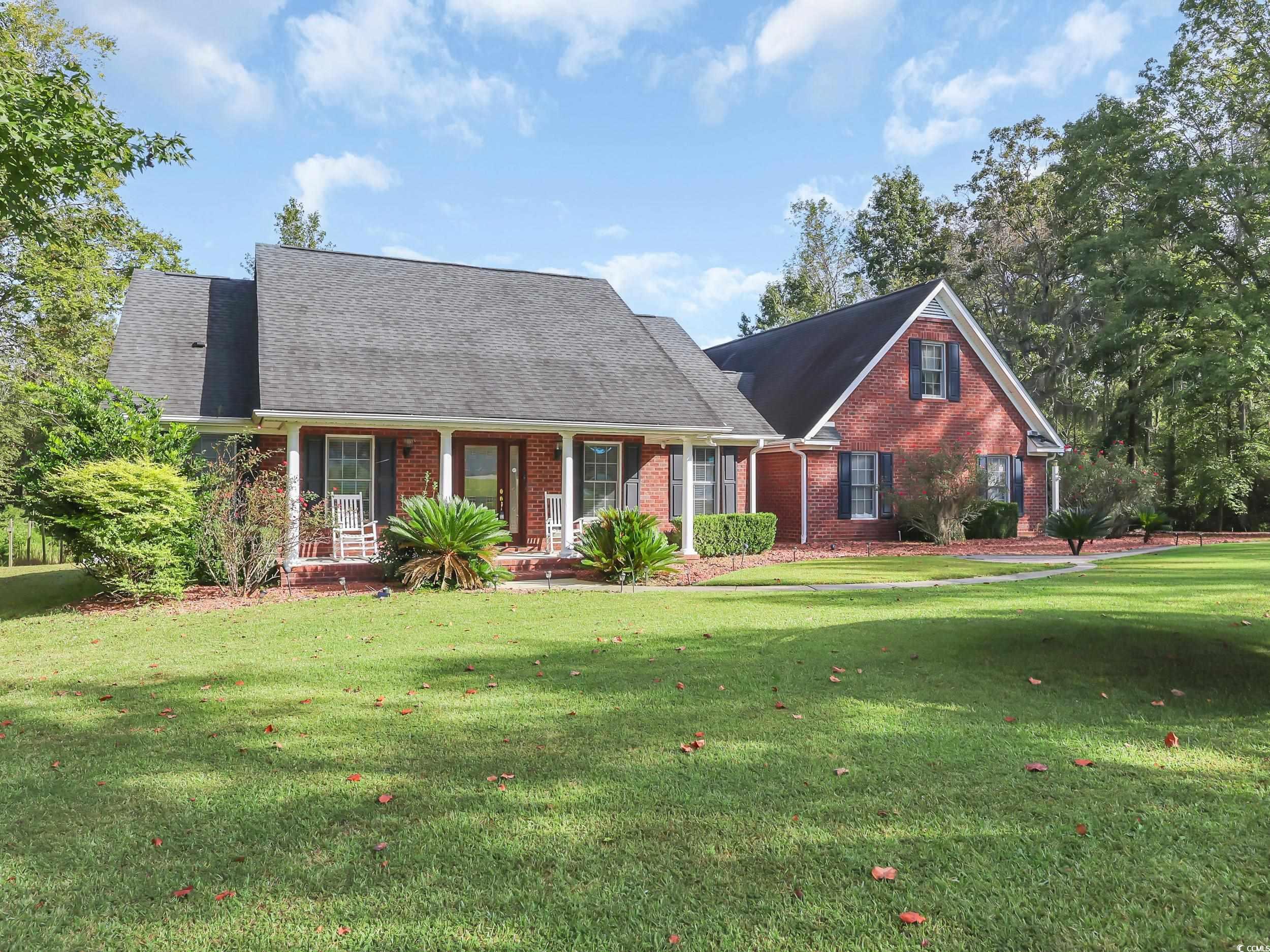3731 Love Lane Conway, SC 29527 - Photo 1 of 32 Cape cod-style house with a porch, brick siding, a front lawn, and roof with shingles