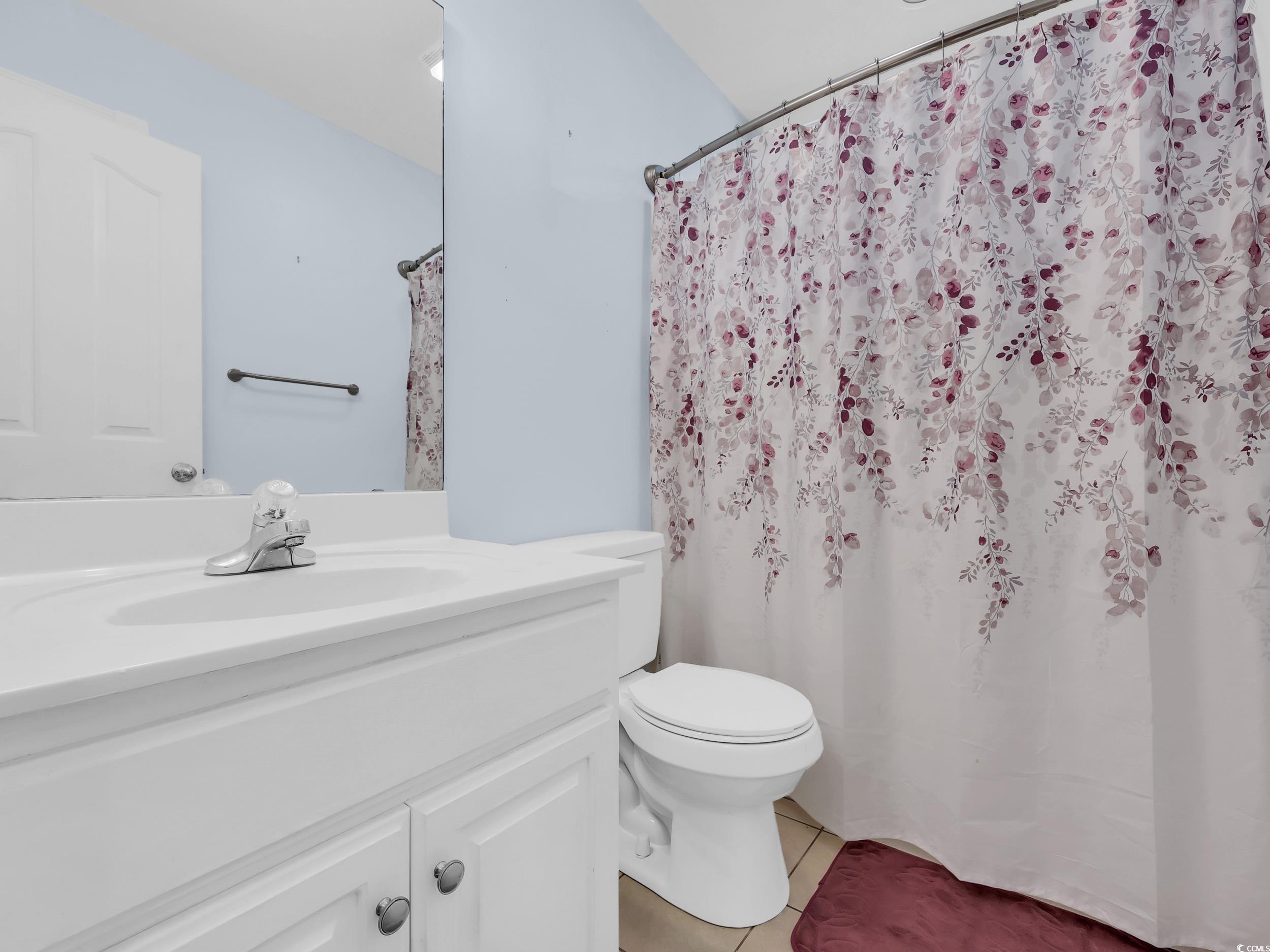 3731 Love Lane Conway, SC 29527 - Photo 18 of 32 Bathroom with vanity, light tile patterned flooring, and a shower with shower curtain