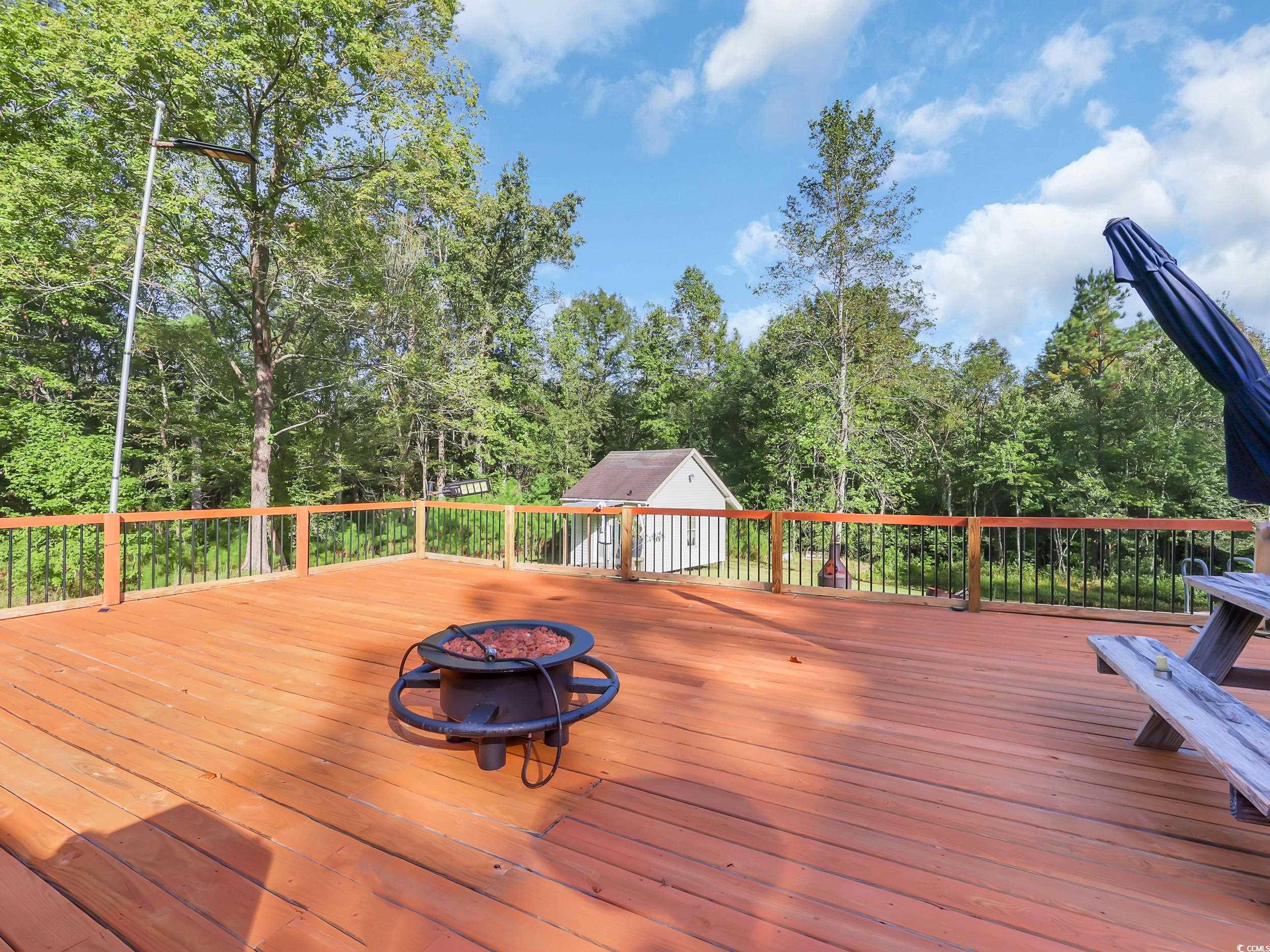 3731 Love Lane Conway, SC 29527 - Photo 23 of 32 Deck with an outdoor fire pit and view of scattered trees