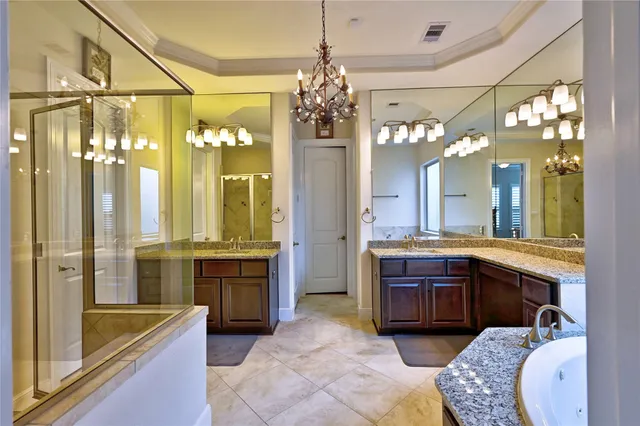 a bathroom with a granite countertop sink a mirror and a shower