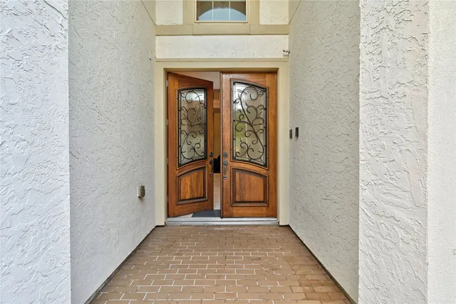 a view of a hallway with entryway wooden floor and dining room view