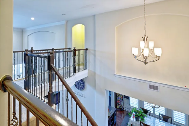 a view of a hallway with wooden floor and stairs