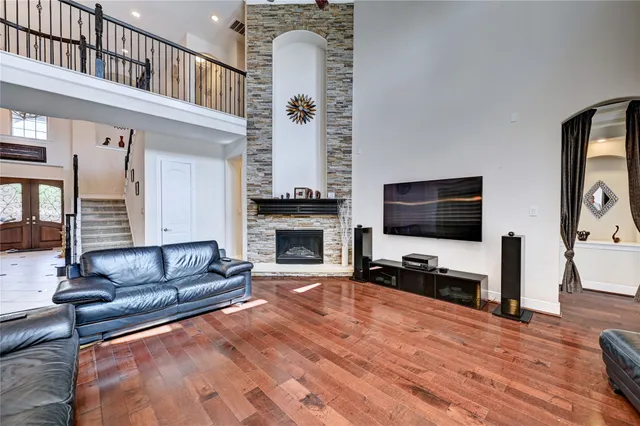 a living room with furniture fireplace and large windows
