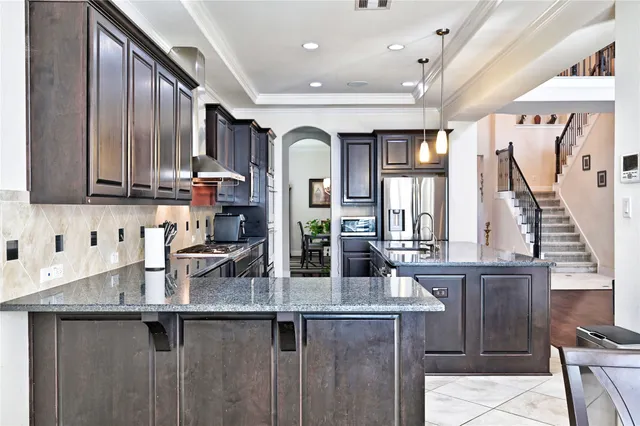 a kitchen with granite countertop a sink and cabinets