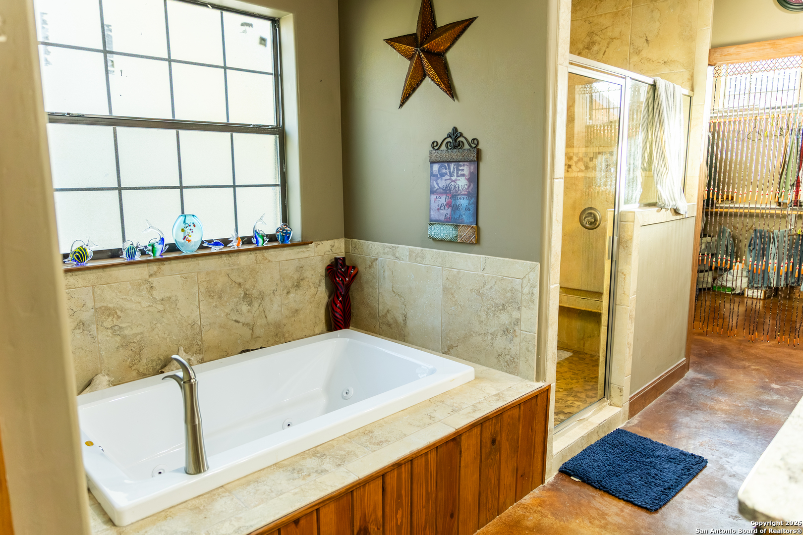 187 Robbins Ranch Road Junction, TX 76849 - Photo 12 of 23 a bathroom with a tub and a shower