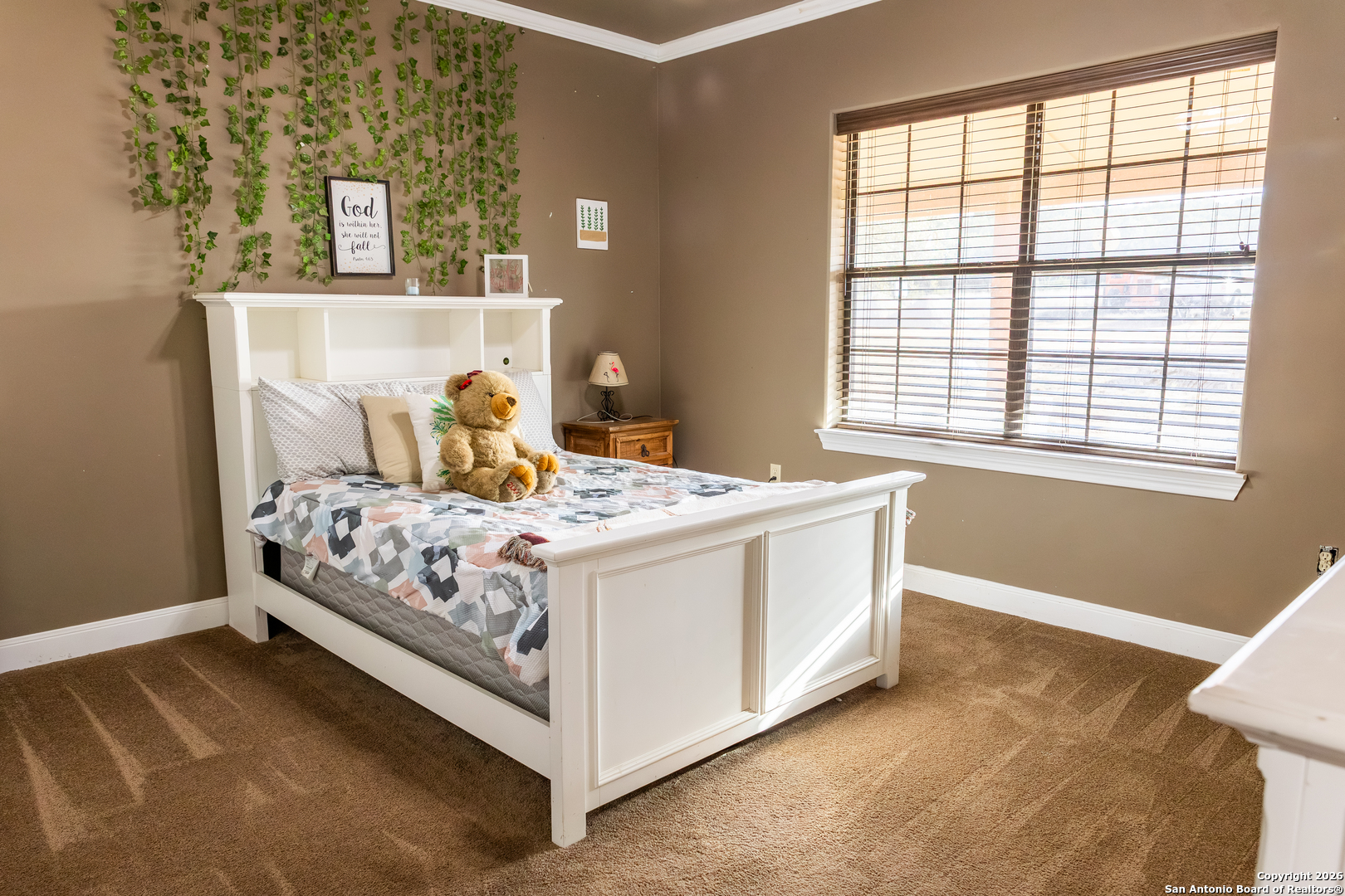 187 Robbins Ranch Road Junction, TX 76849 - Photo 16 of 23 a bed sitting in a bedroom next to a window