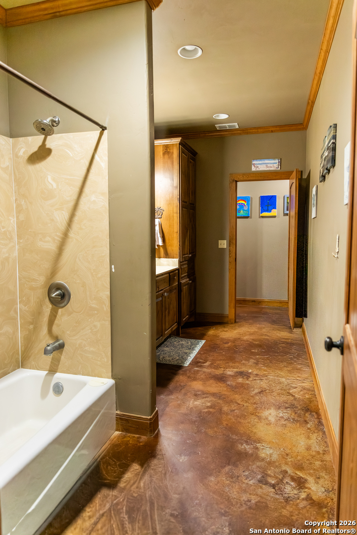 187 Robbins Ranch Road Junction, TX 76849 - Photo 19 of 23 a bathroom with a tub sink and mirror