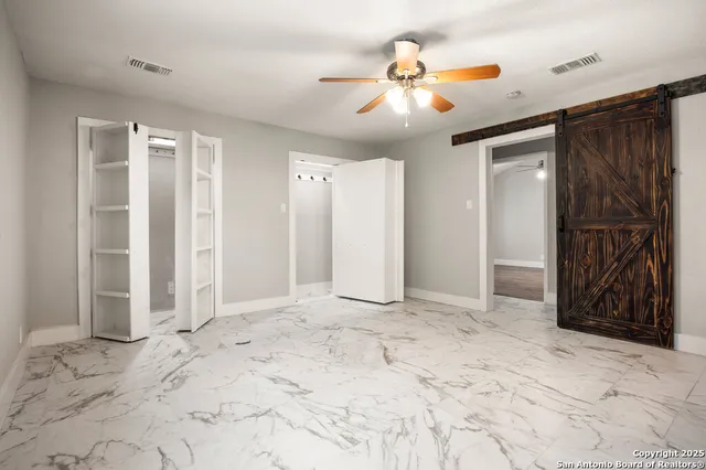 a view of a livingroom with a chandelier fan and closet area