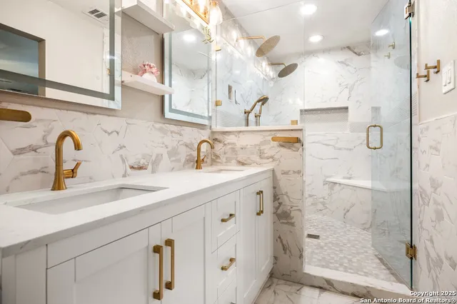 a bathroom with a shower sink and mirror