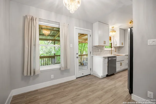 a kitchen with a sink cabinets stainless steel appliances and a window
