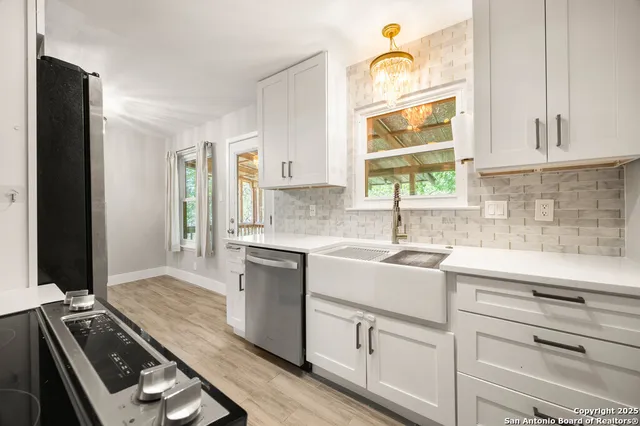 a kitchen with a sink stove and microwave
