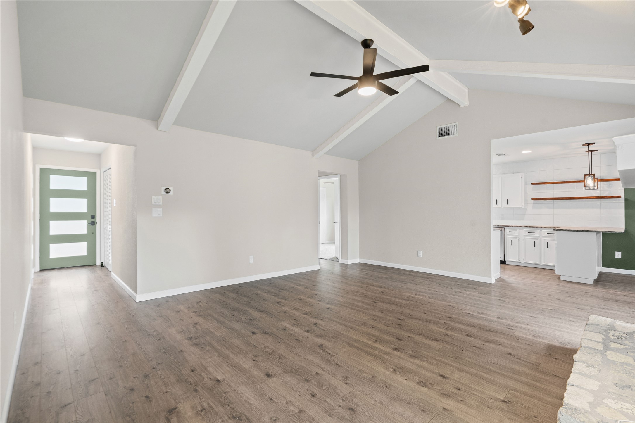 810 Stillhouse Spring Round Rock, TX 78681 - Photo 7 of 18 An inviting open-concept living area with vaulted ceilings flows seamlessly into the kitchen.