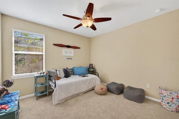 a bedroom with two bed and a window