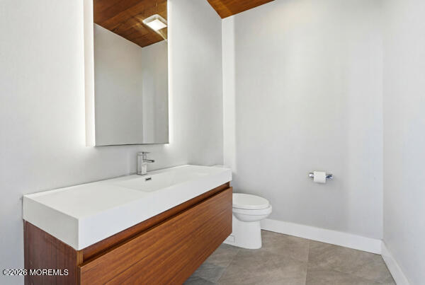 54 Georgetown Road Eatontown, NJ 07724 - Photo 22 of 24 a bathroom with a sink a toilet and a mirror