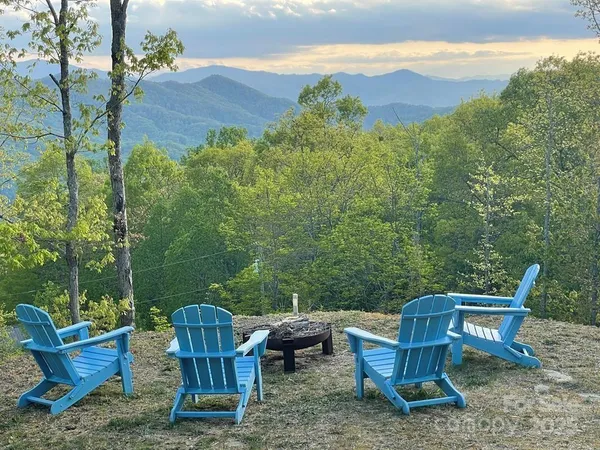 a view of a chair and table in the back yard