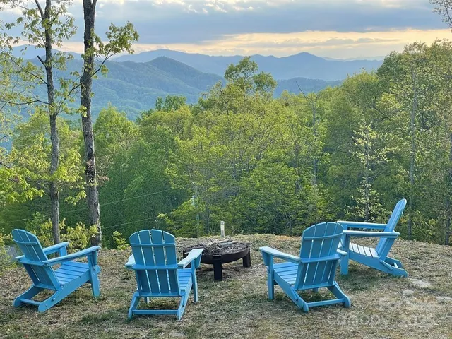 a view of a chair and table in the back yard
